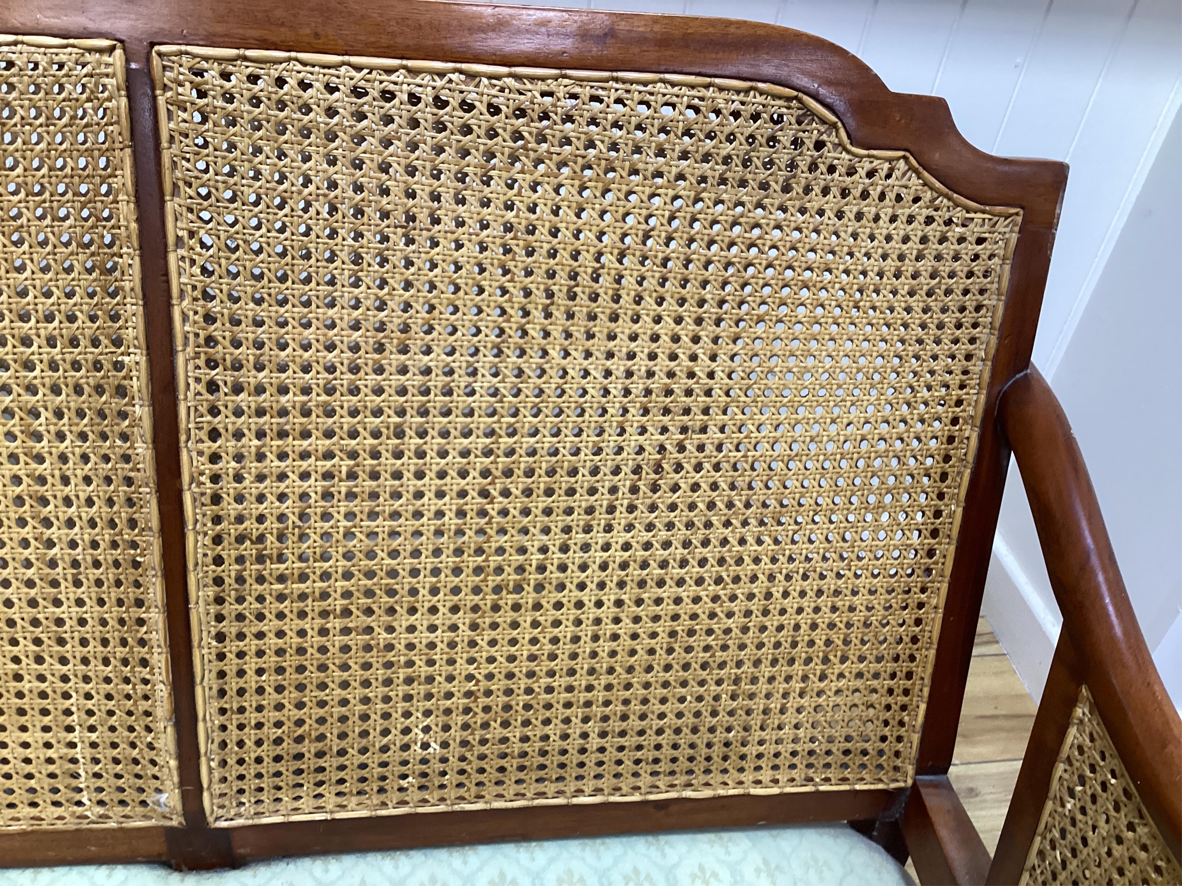 A mahogany double caned bergere settee with loose cushion seat and back, width 178cm, depth 78cm, height 87cm